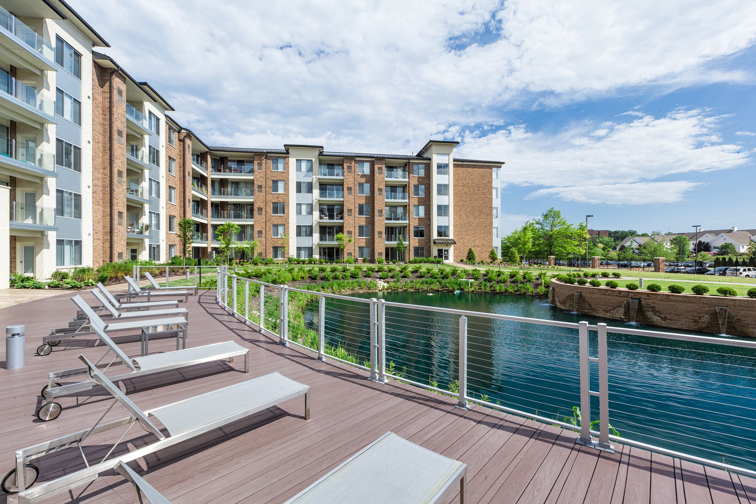 Exterior view of Four Seasons with lounge chairs and a lake